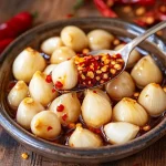 Konfierter Knoblauch mit Chiliflocken First Image First Image